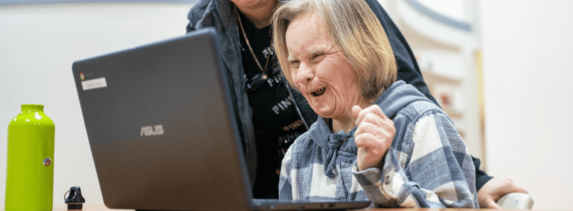 a woman happy and using a computer