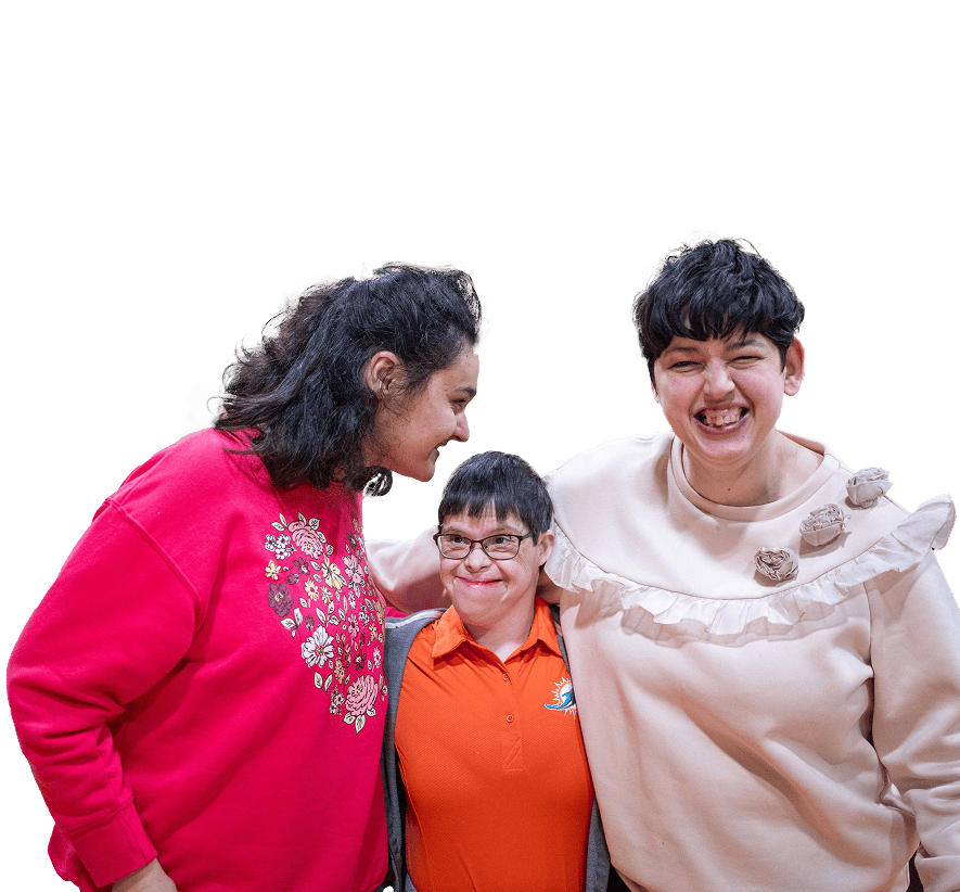 3 women standing, smiling with their arms around each other