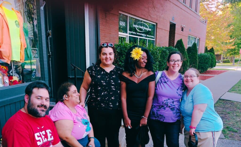 A group of friends standing in front of a shop