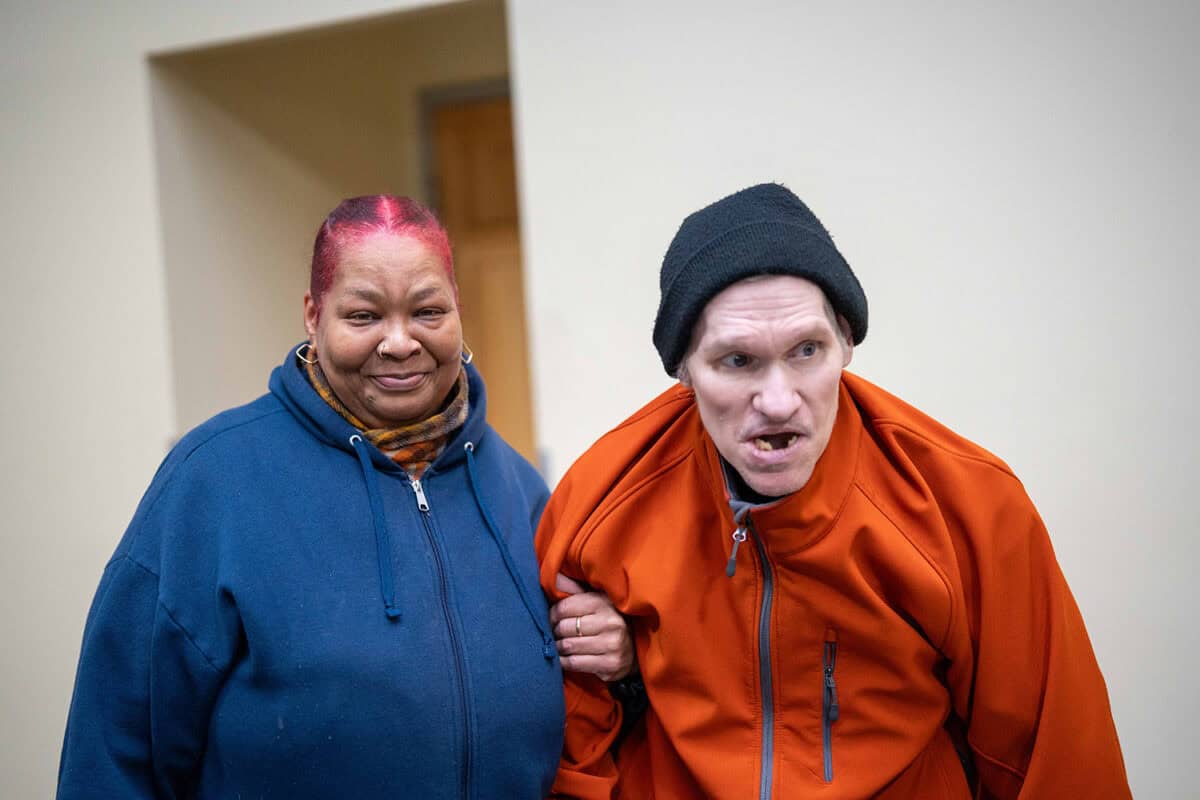 A man and woman arm-in-arm