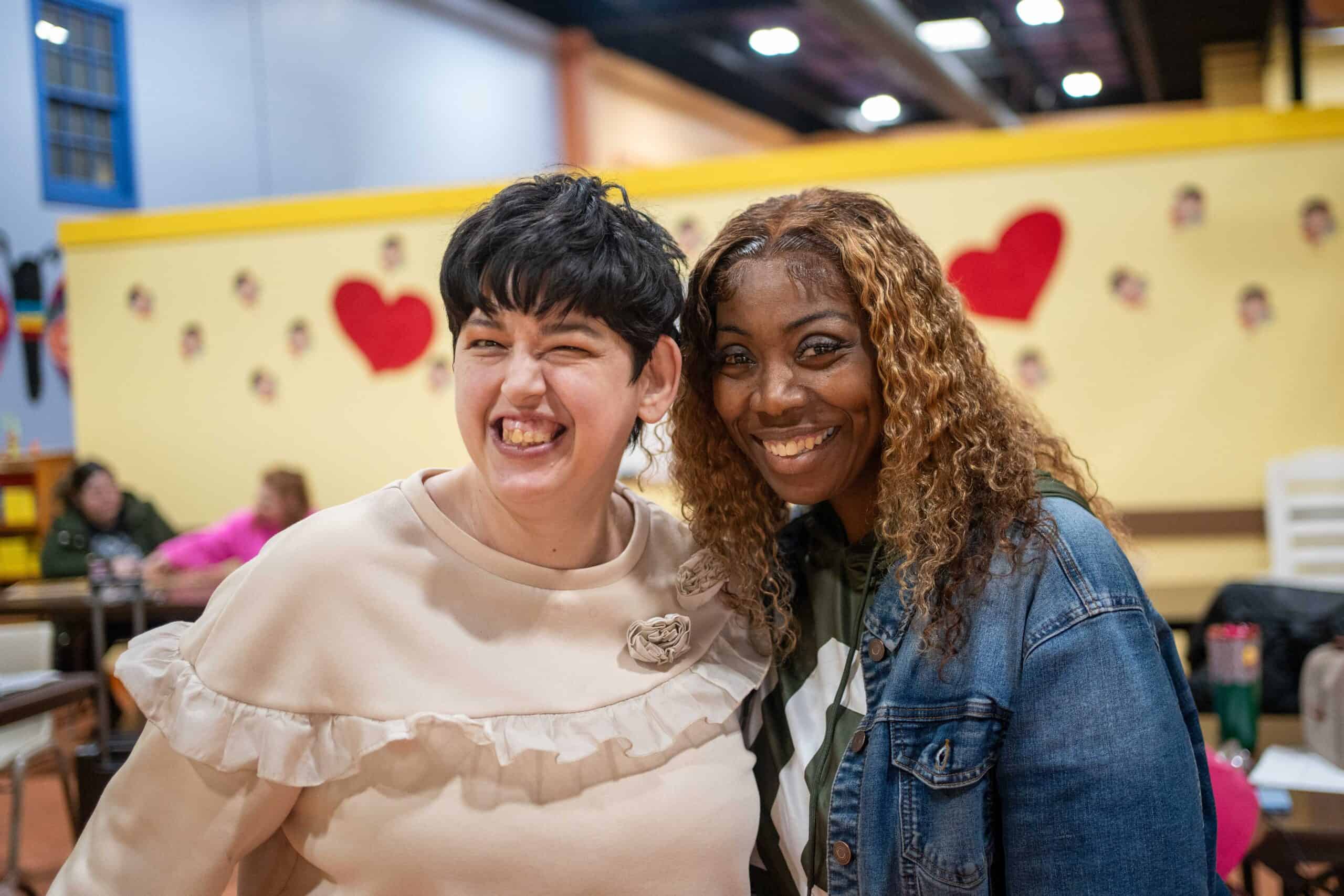 Two women close together, smilng