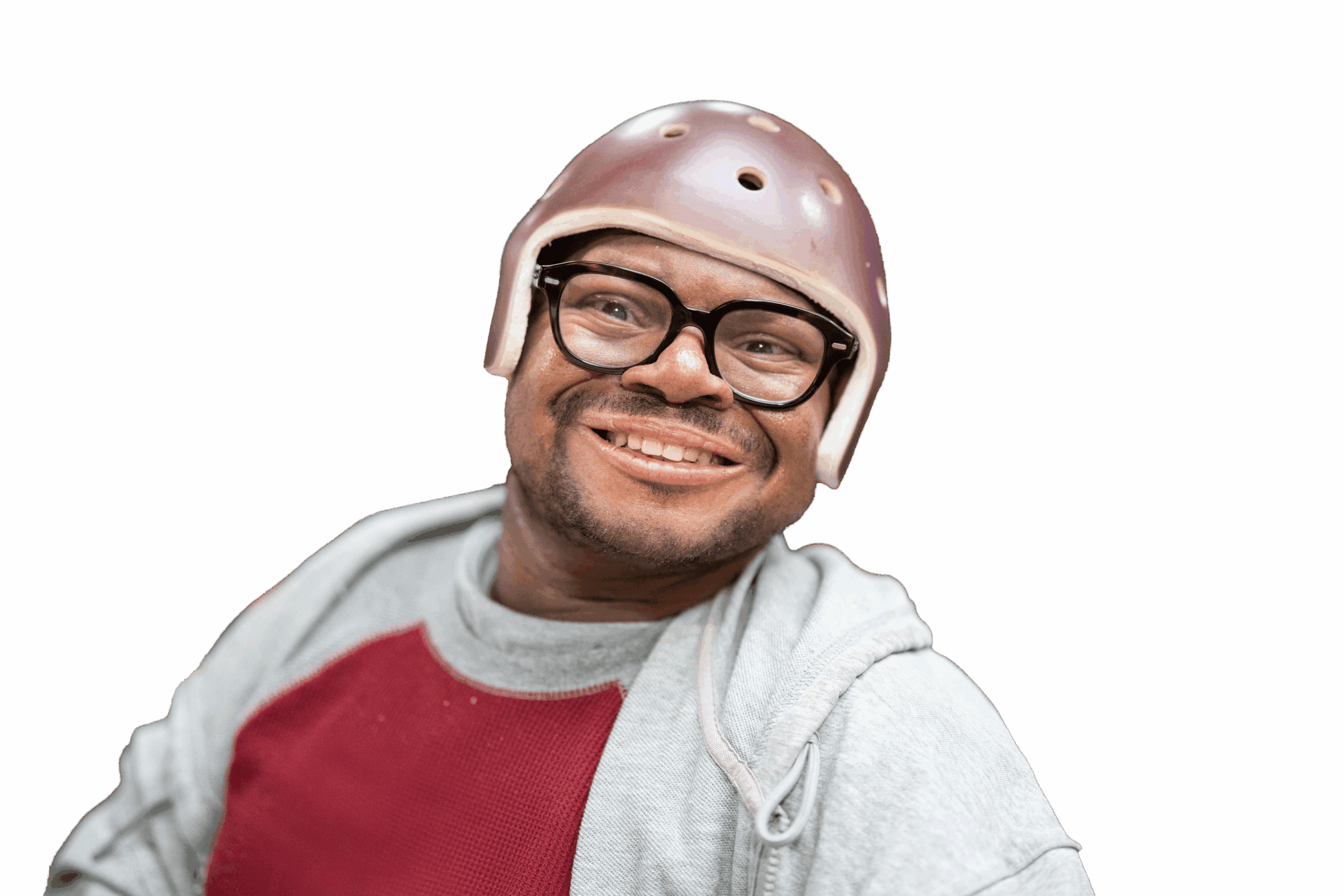 A man wearing a protective head cap and glasses smiling at the camera