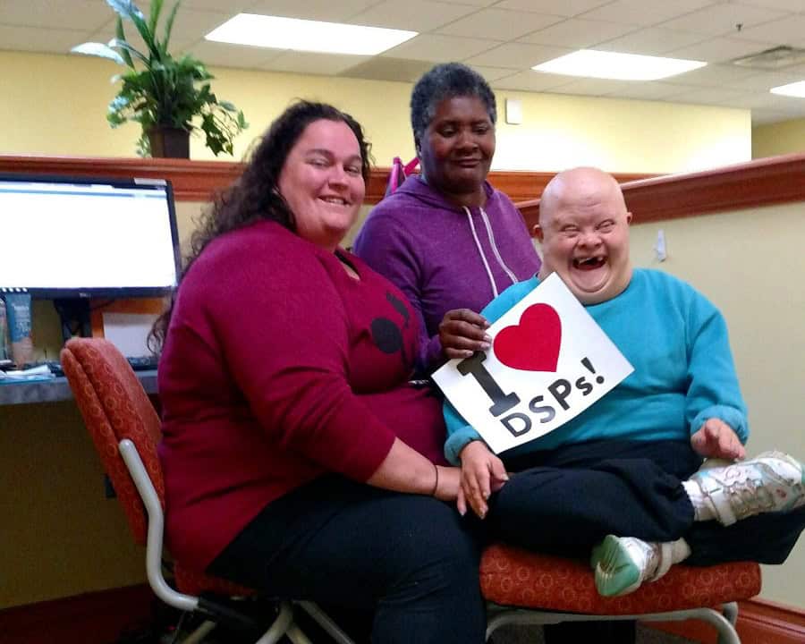Three people holding an "I Heart DSPs" sign