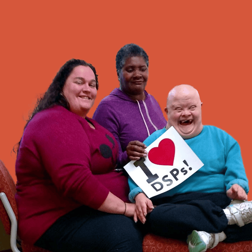 Three people holding an "I Heart DSPs" sign