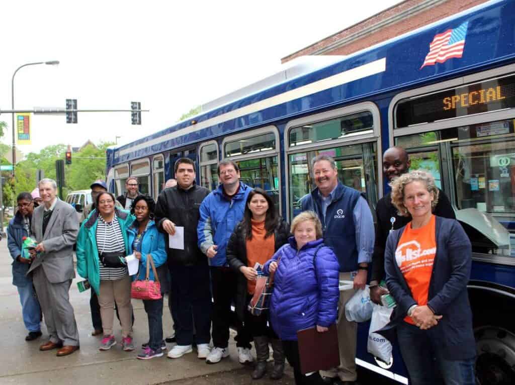 A group of people in front of a bus