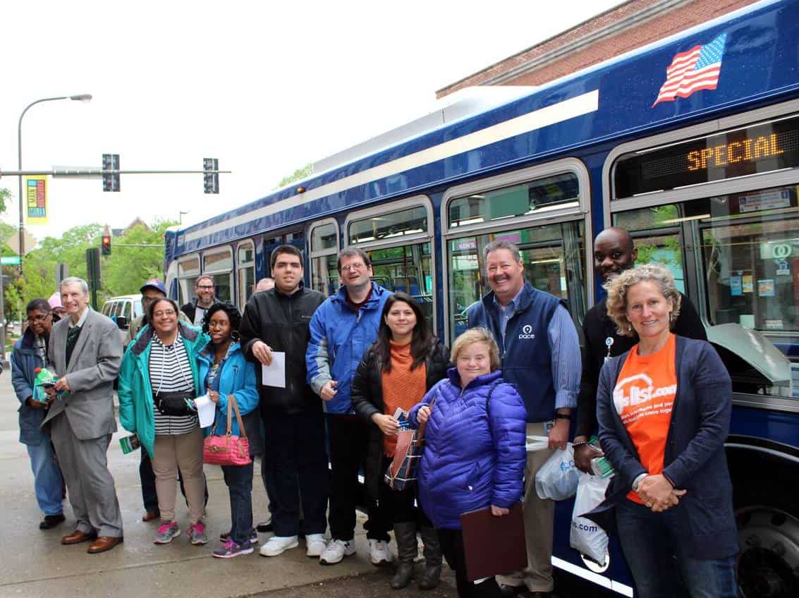 A group of people in front of a bus