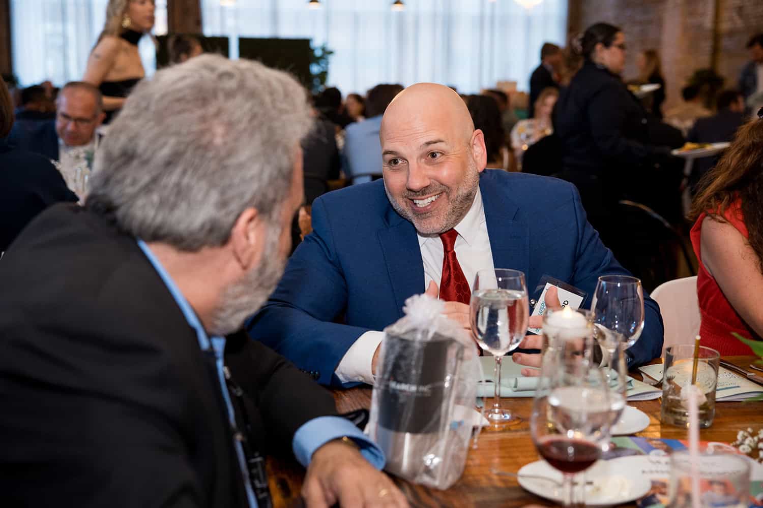 Associate board members talking at a gala