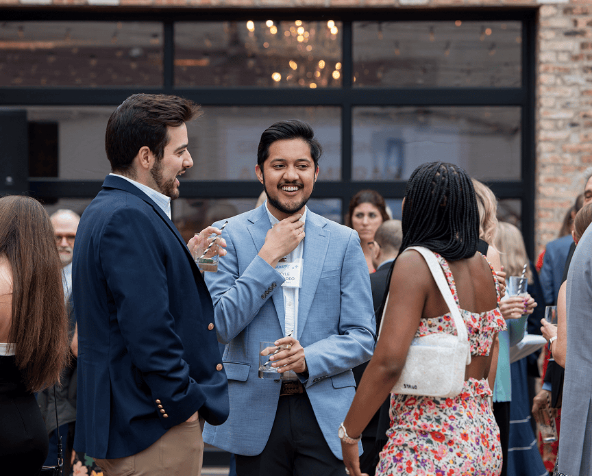 3 people pictured, 2 with their back to the camera in formal wear