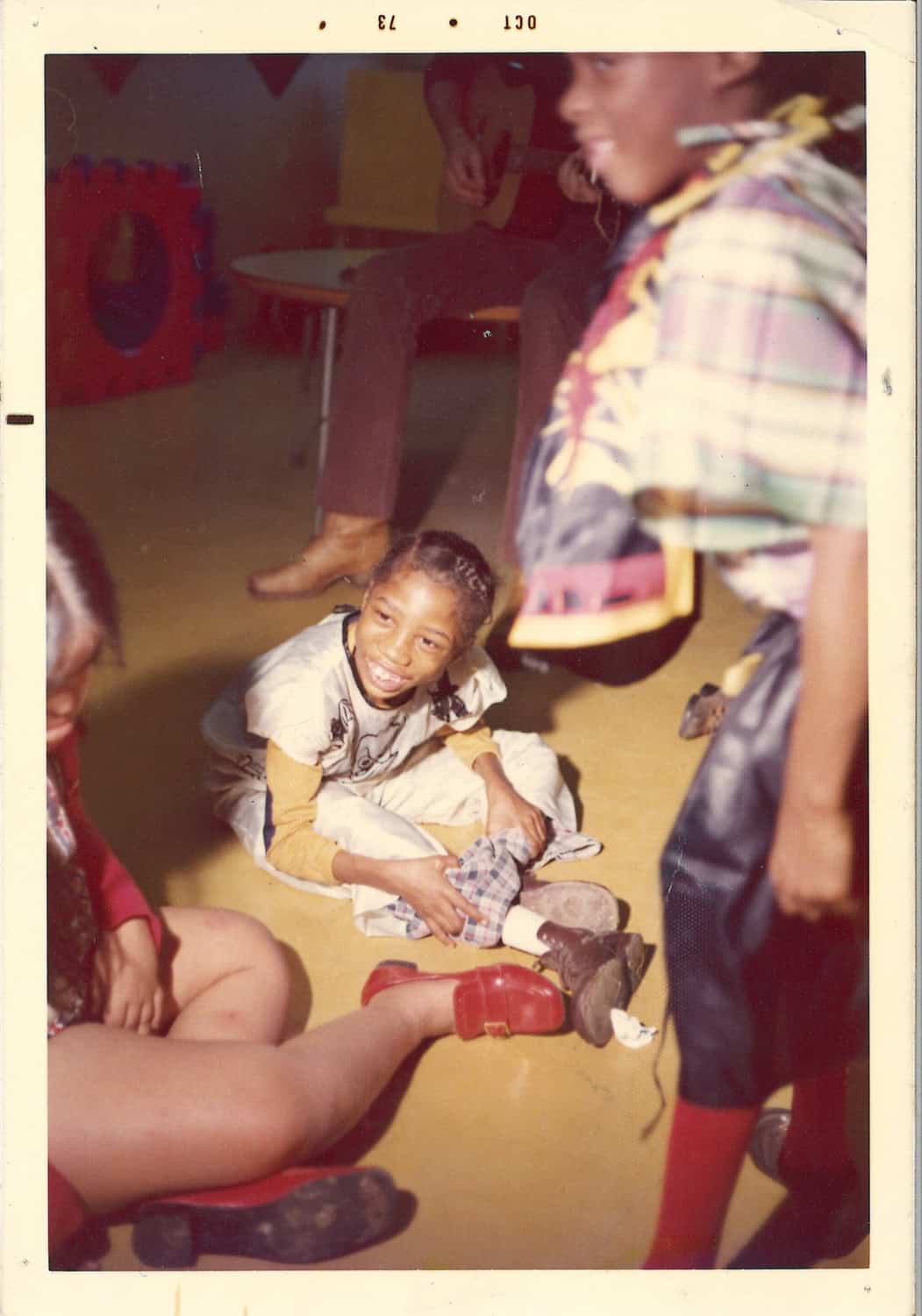 Two people smiling at the camera, head to head