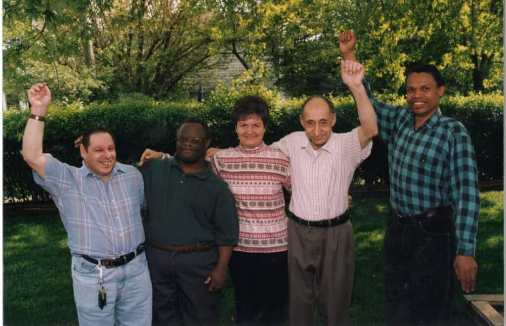 a group of people smiling and waving