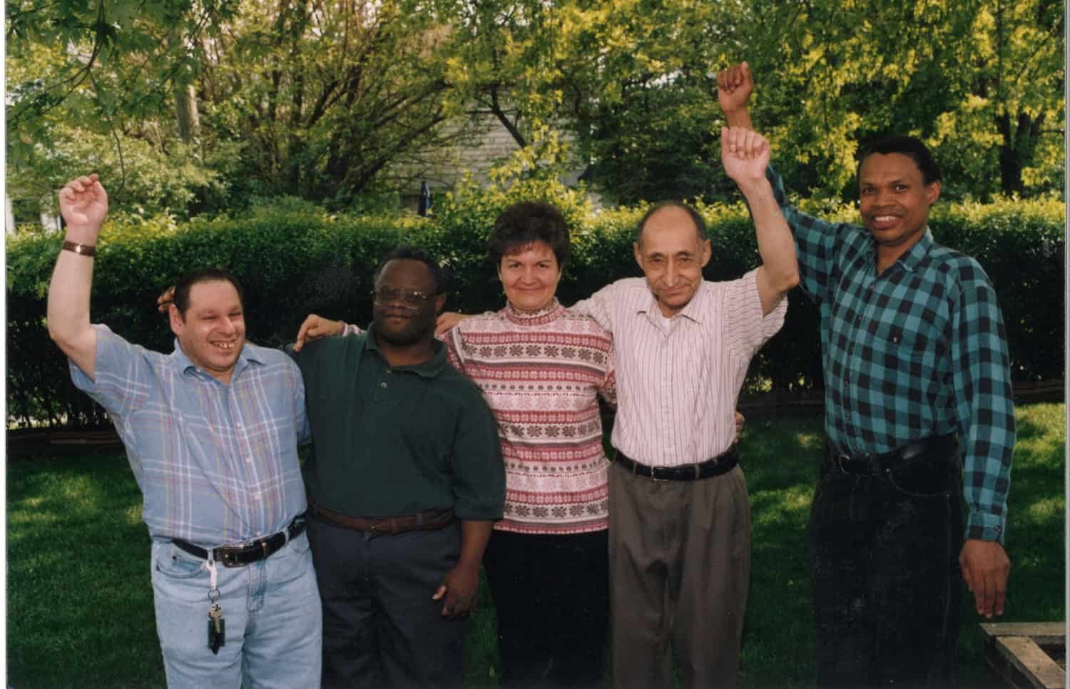 a group of people smiling and waving