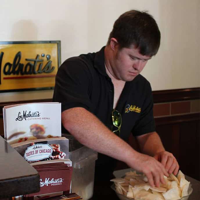 a young man working at a restaurant 